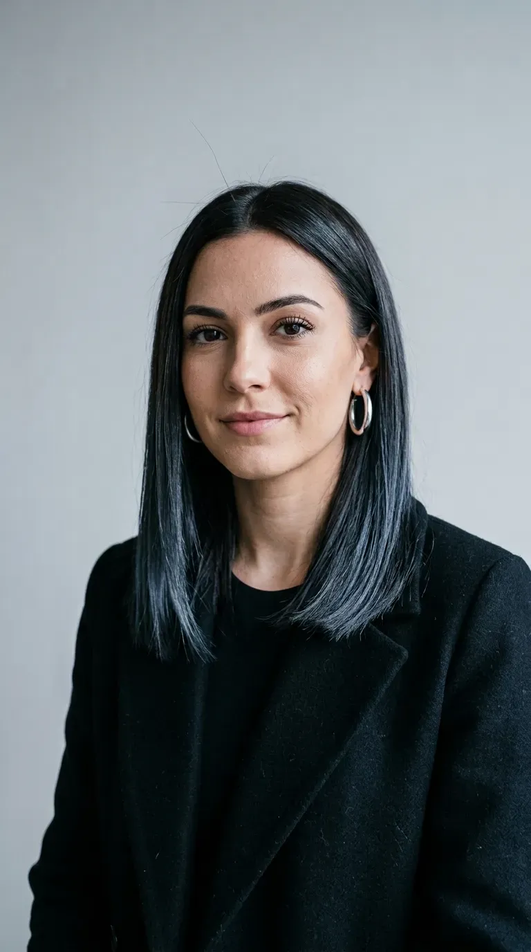 Woman with dark brunette hair featuring subtle icy blue-black balayage sheen
