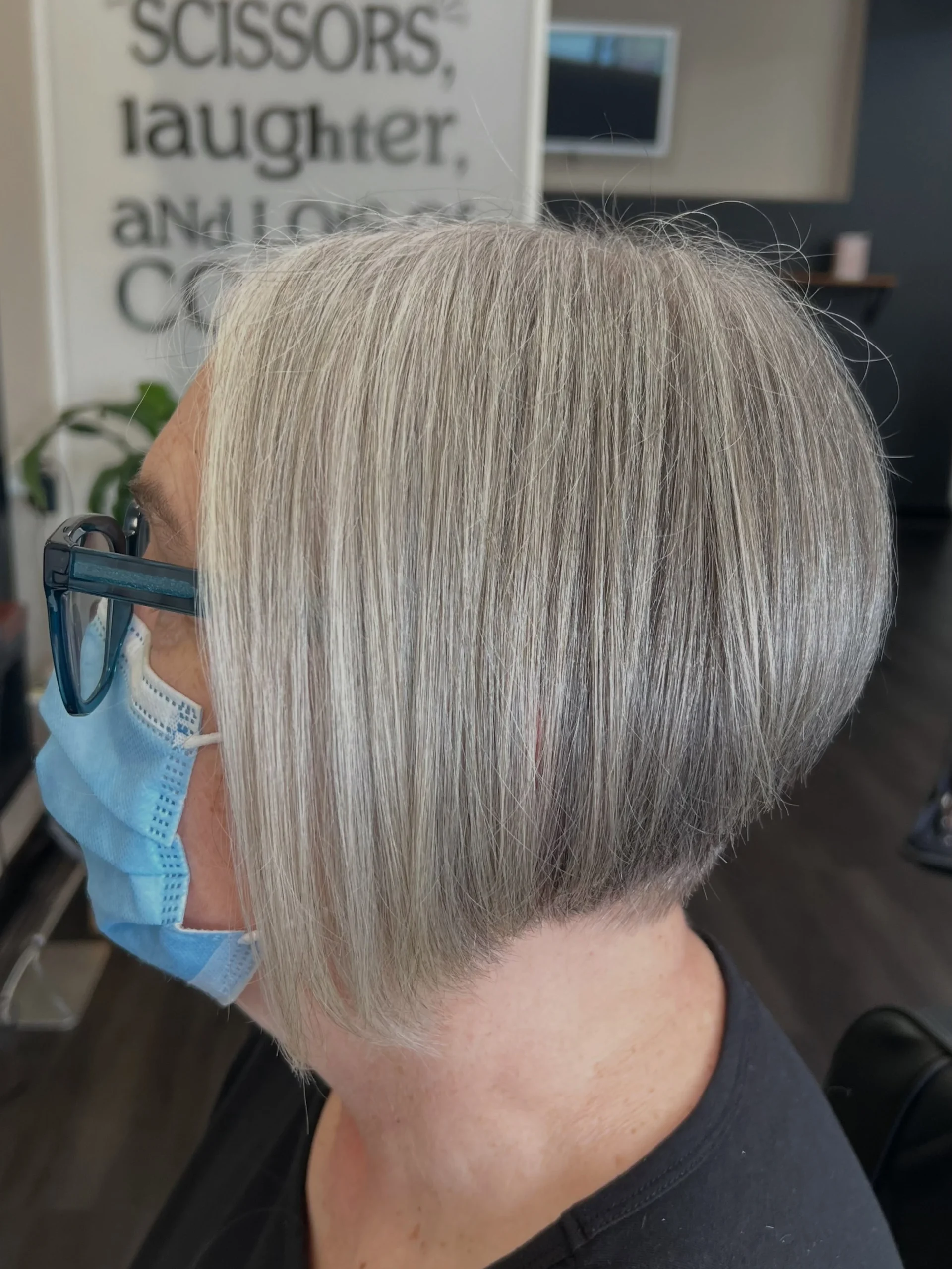 Woman over 60 with angled bob haircut that is longer in the front