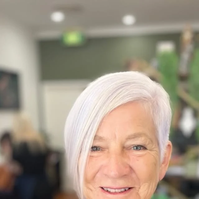 Woman over 60 with asymmetrical bob haircut featuring a bold length difference