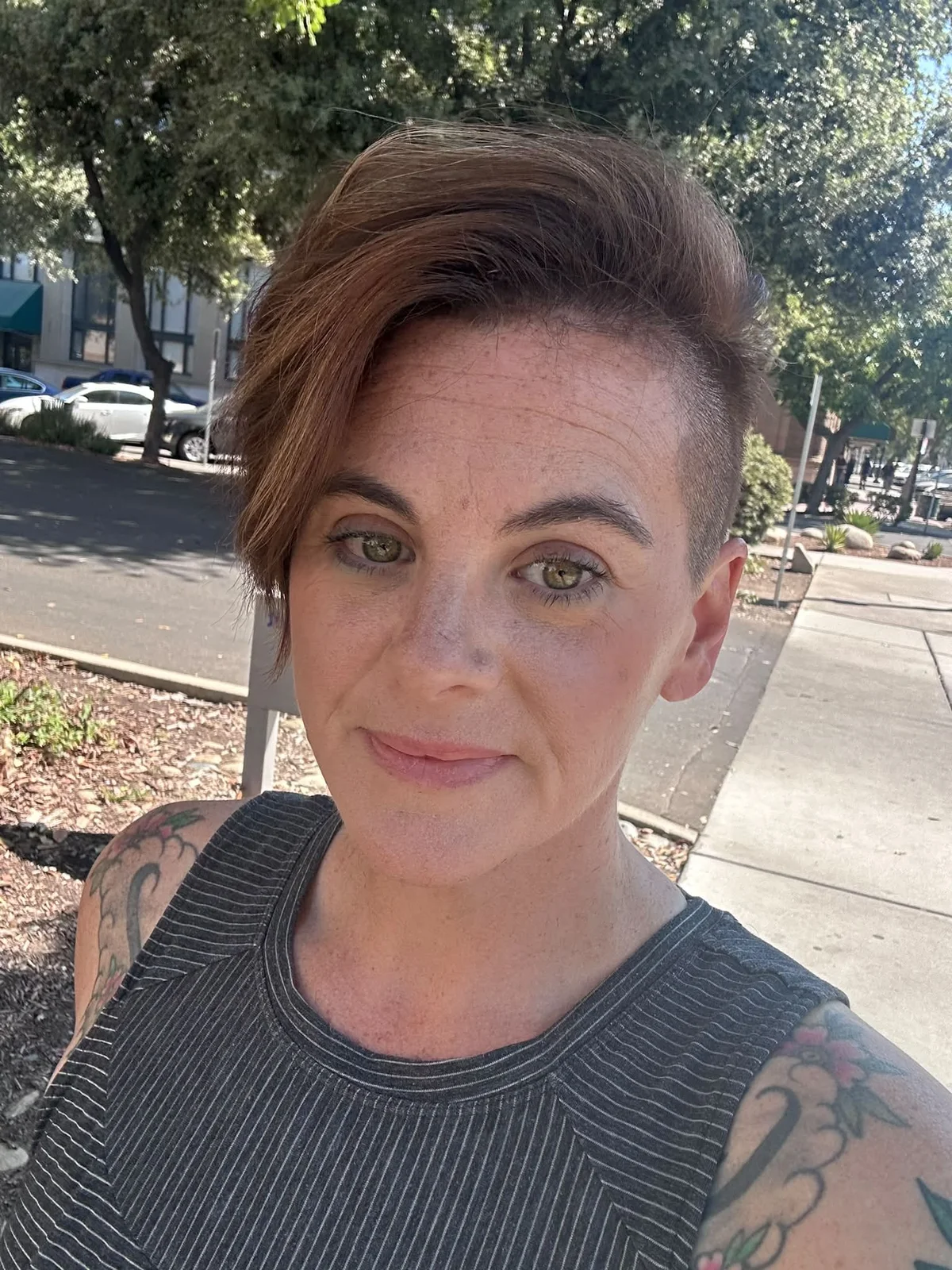 Woman with an edgy asymmetrical pixie with one side shaved shorter than the other