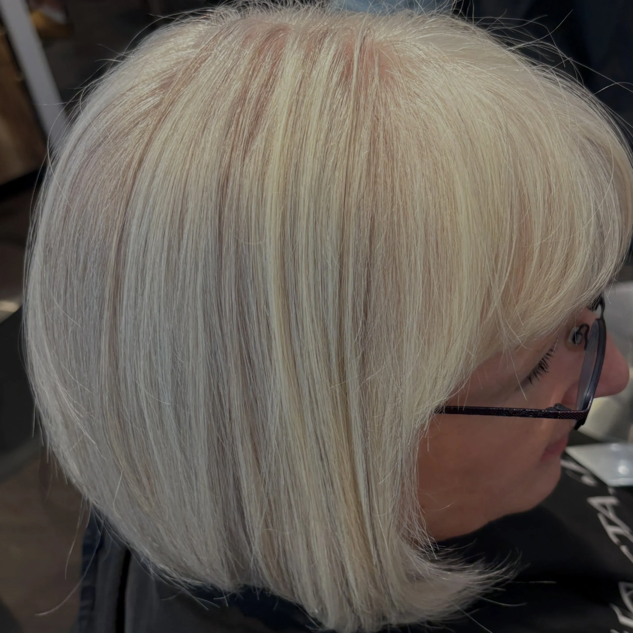 Woman over 60 with natural gray or white hair styled in a bob