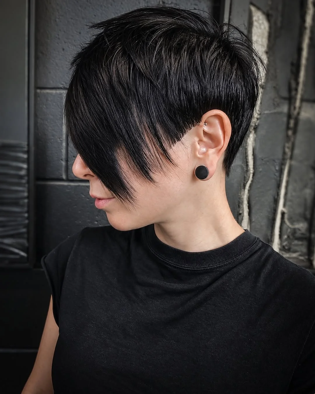 Woman with an edgy pixie featuring a disconnected undercut with a sharp visible line