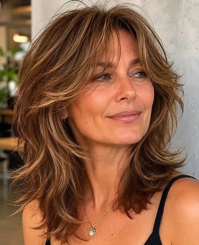 Woman over 50 with fine hair wearing face-framing layers styled around the face