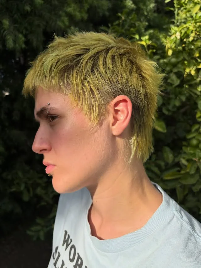 Woman with an edgy pixie styled into a faux hawk with lifted center volume