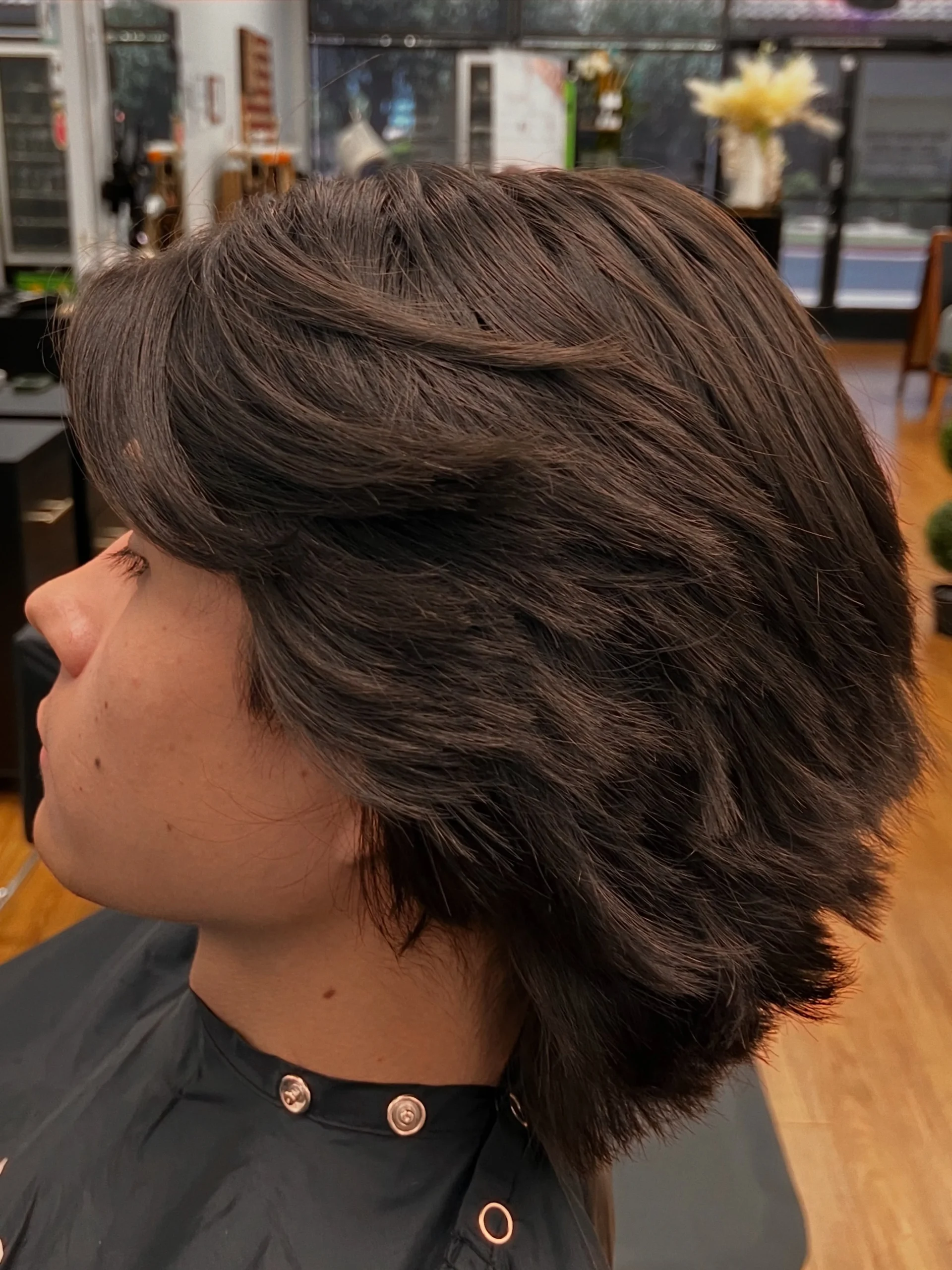 Woman with thin fine hair wearing a feathered shag bob with soft blended layers