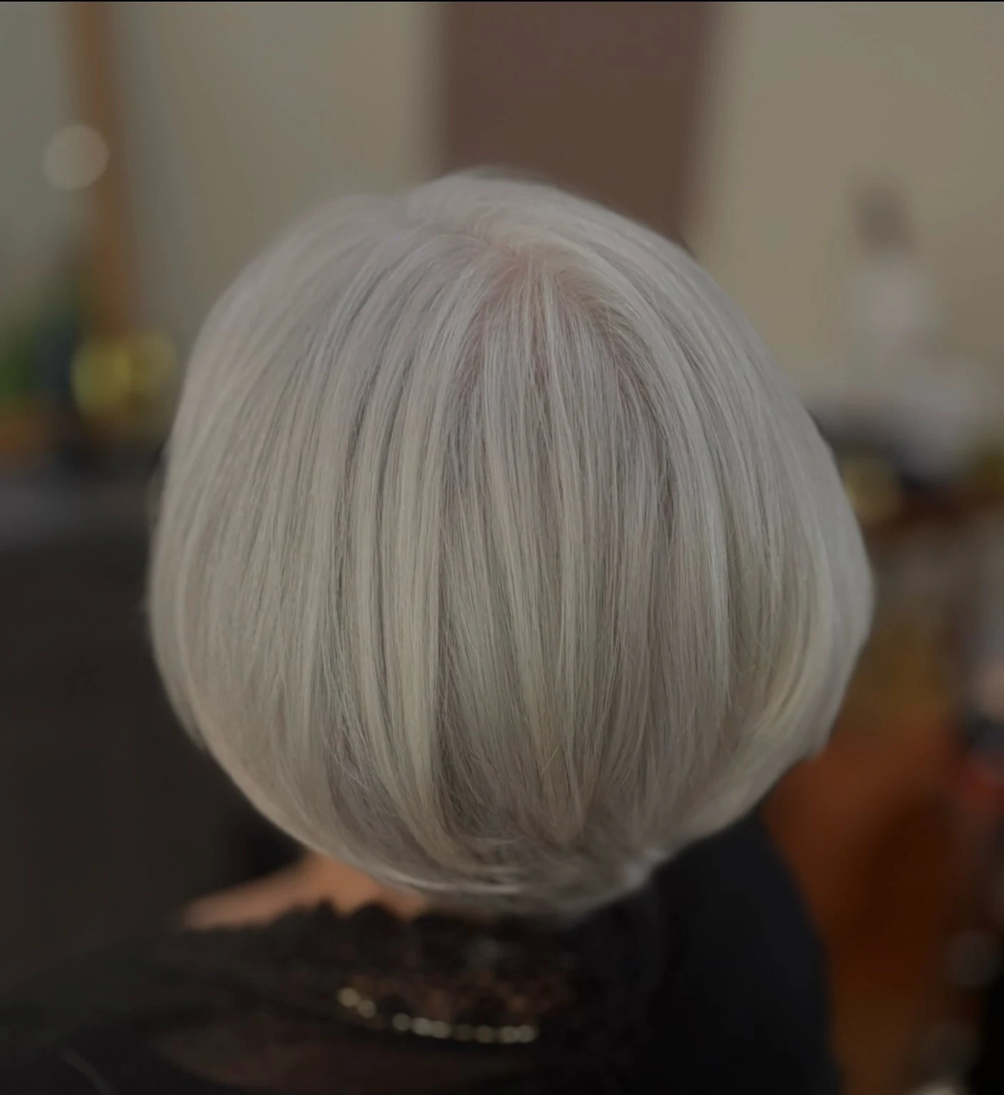 Close-up of glossy shine serum applied to a bob hairstyle for women over 60