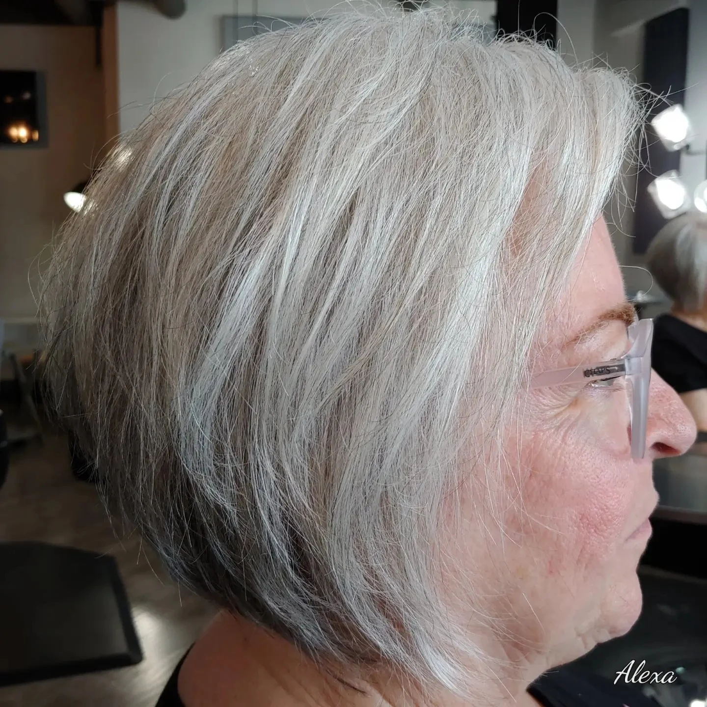 Woman over 60 with inverted bob haircut featuring a rounded graduated shape