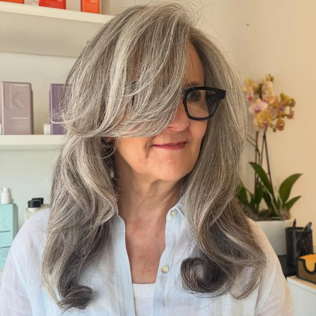 Woman over 50 with fine hair wearing a long shag with feathered face-framing layers