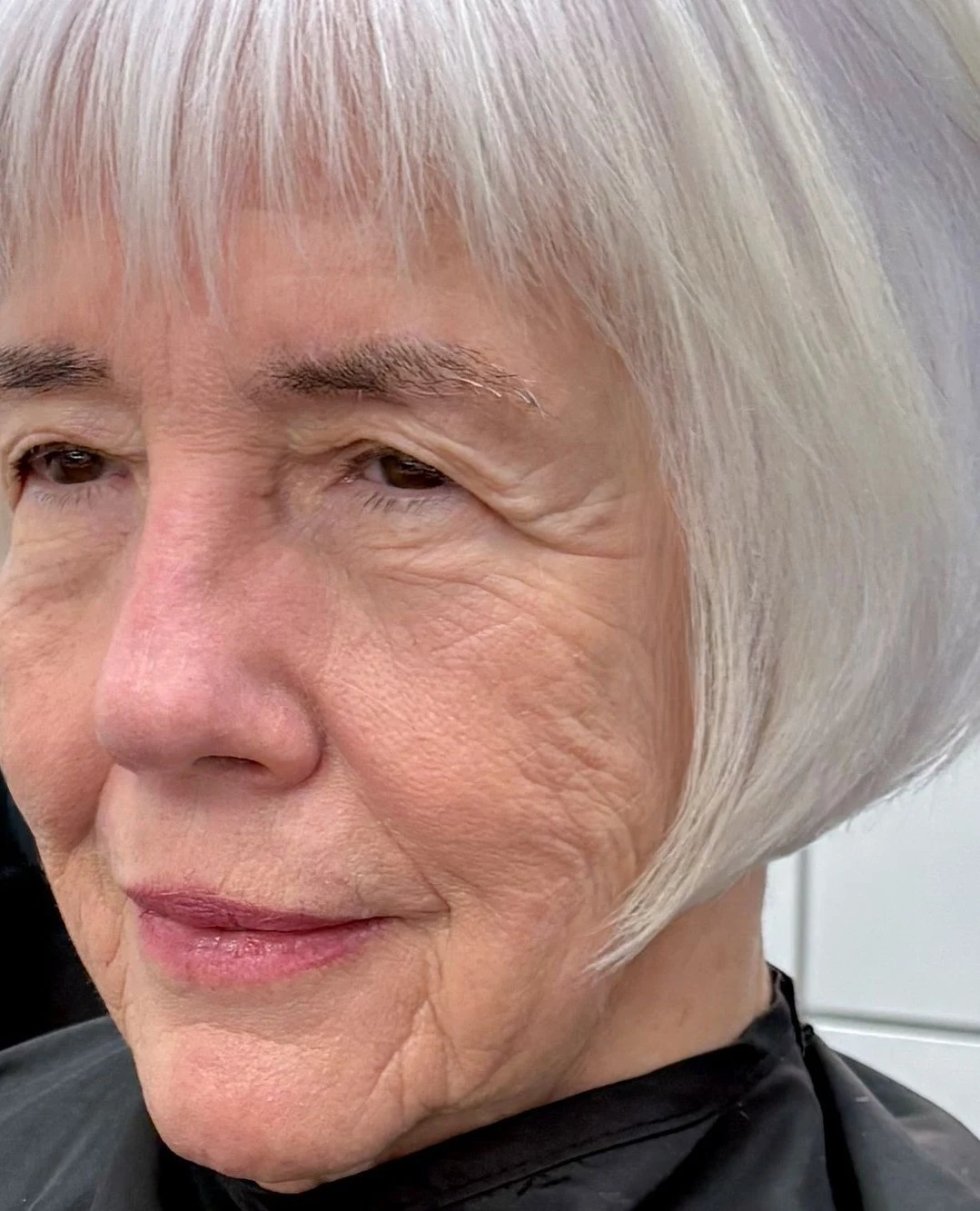 Woman over 60 with low-maintenance wash-and-go bob hairstyle