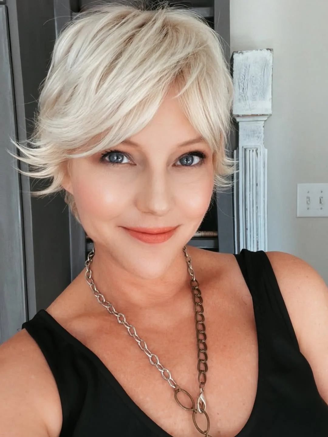 Woman over 50 with fine hair wearing a piece-y crop with soft wispy bangs
