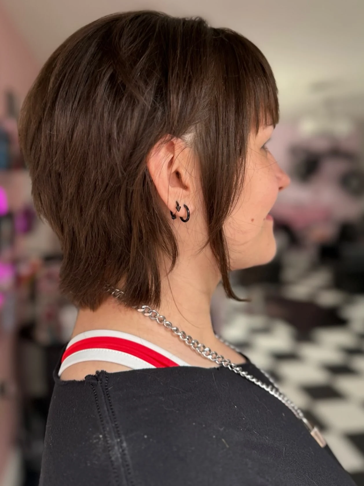 Woman with thin fine hair wearing a piece-y shag bob with defined separated ends