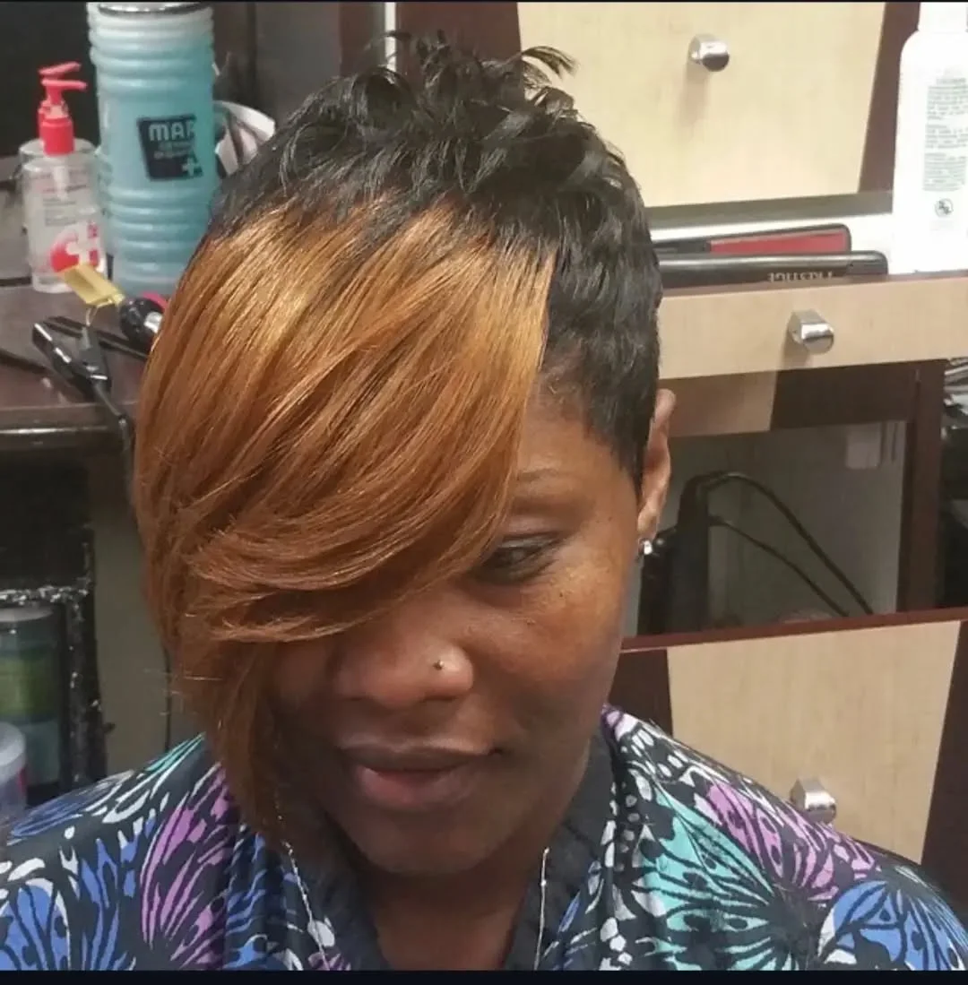 Woman with an edgy pixie featuring an asymmetrical fringe cut on a sharp angle