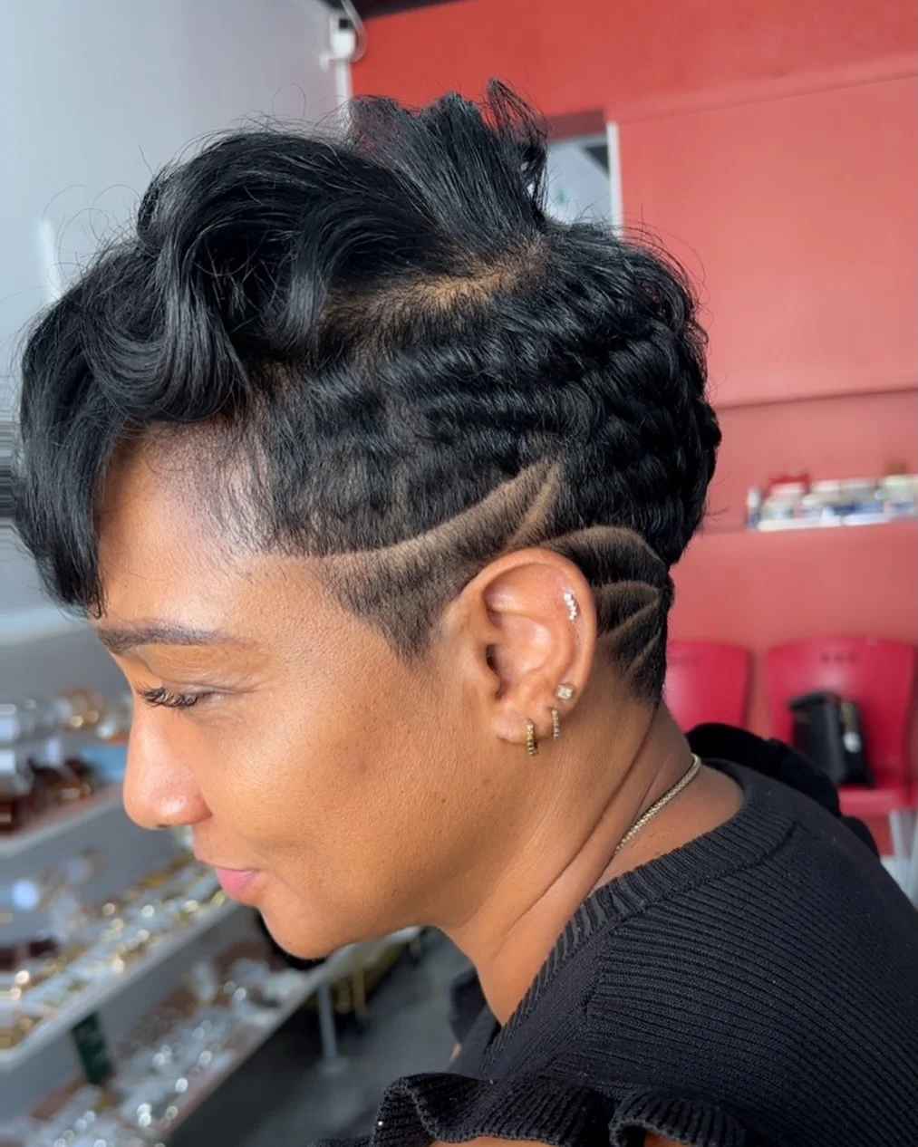 Woman with an edgy pixie featuring a geometric shaved pattern on one side