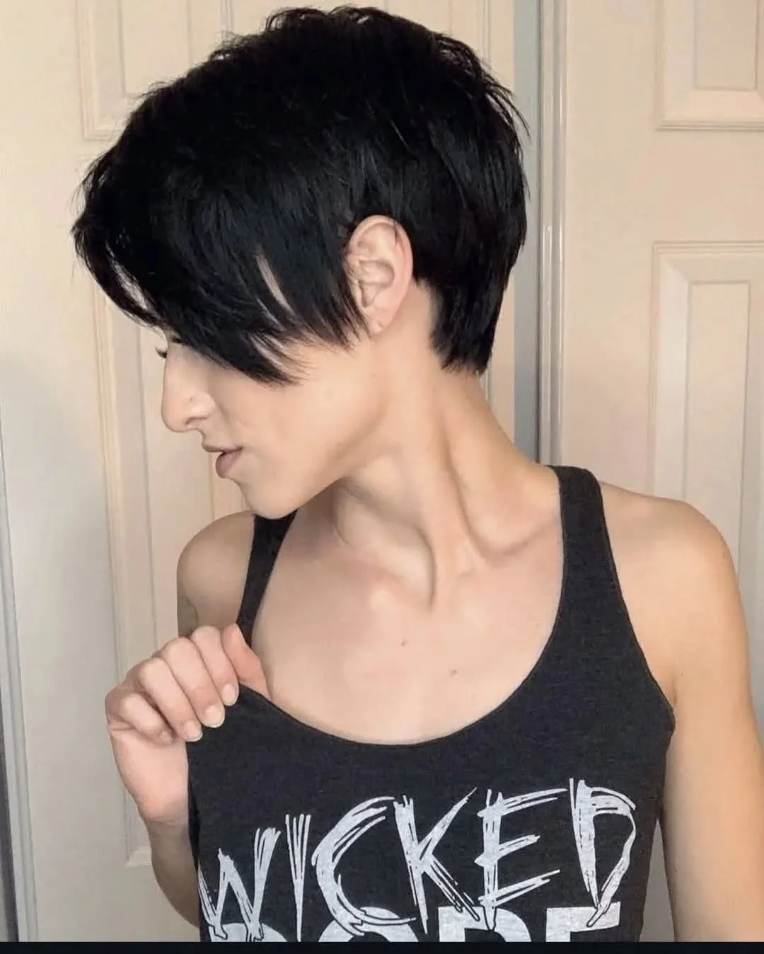 Woman with an edgy pixie featuring a long, textured fringe swept to one side