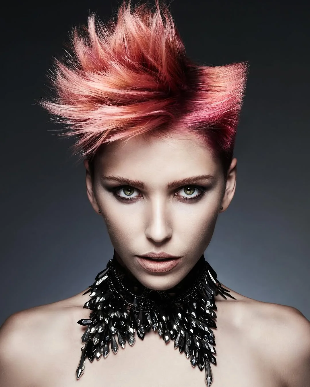 Woman with an edgy punk-inspired pixie styled with tall, defined spikes