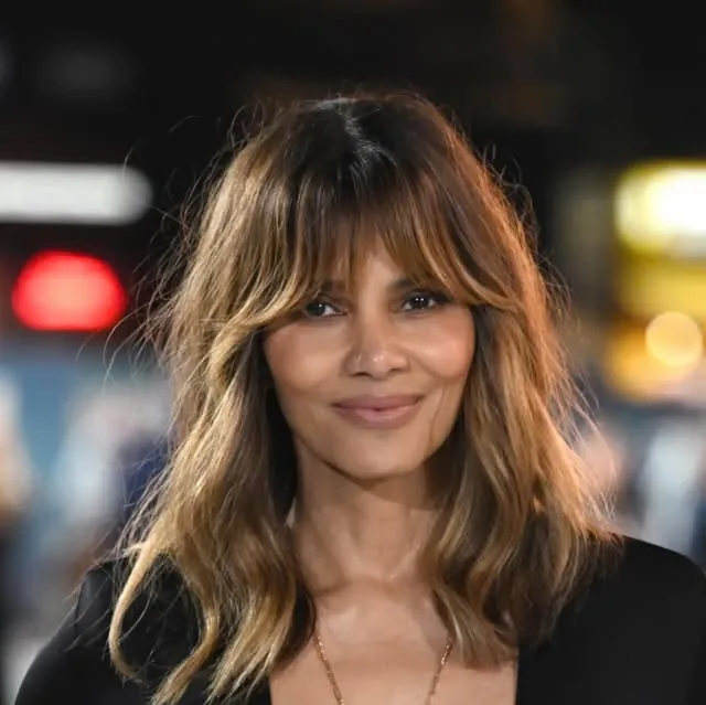 Woman over 50 with fine hair wearing a shag haircut with choppy textured layers