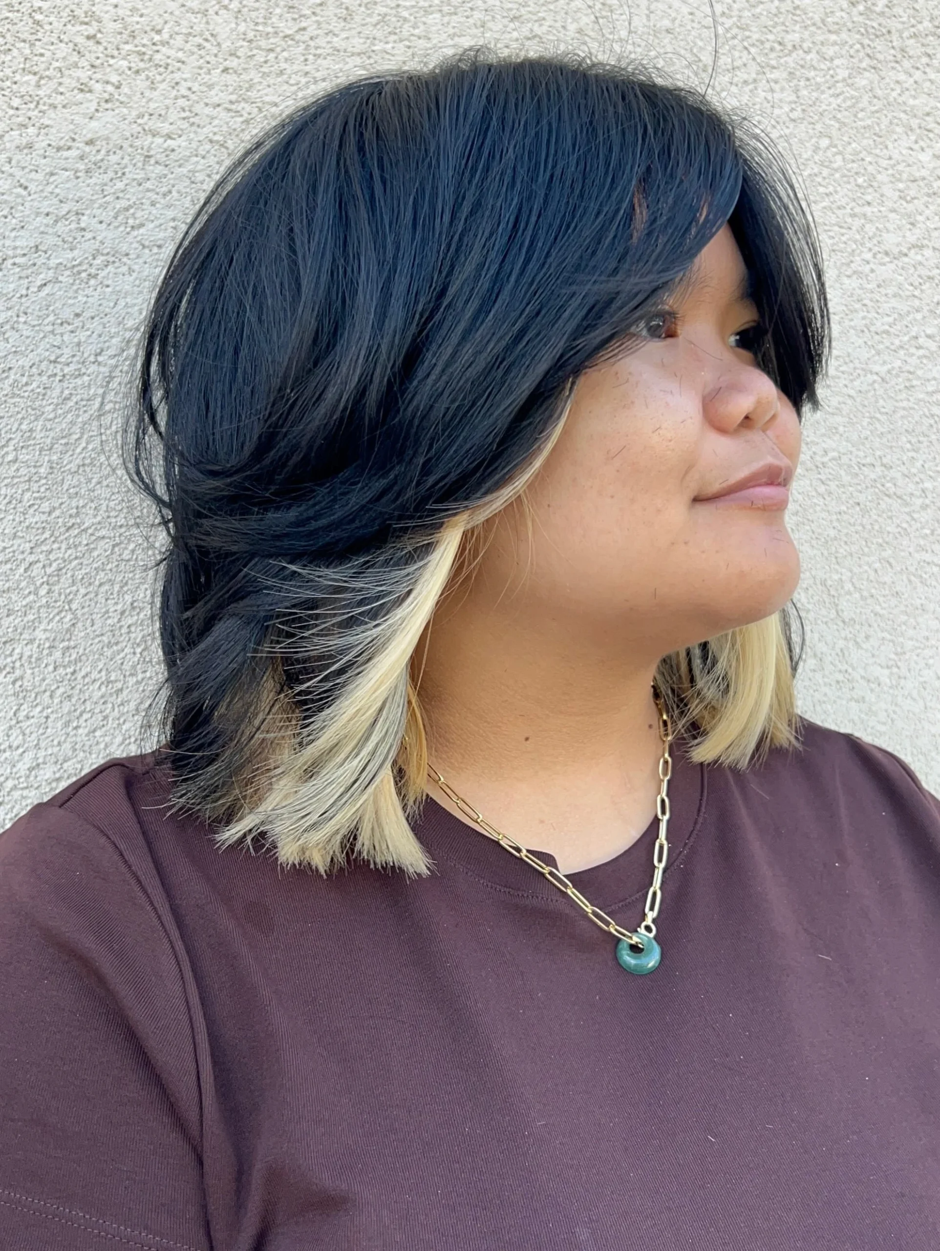 Woman with thin fine hair wearing a shaggy bob featuring a blunt underlayer for hidden thickness