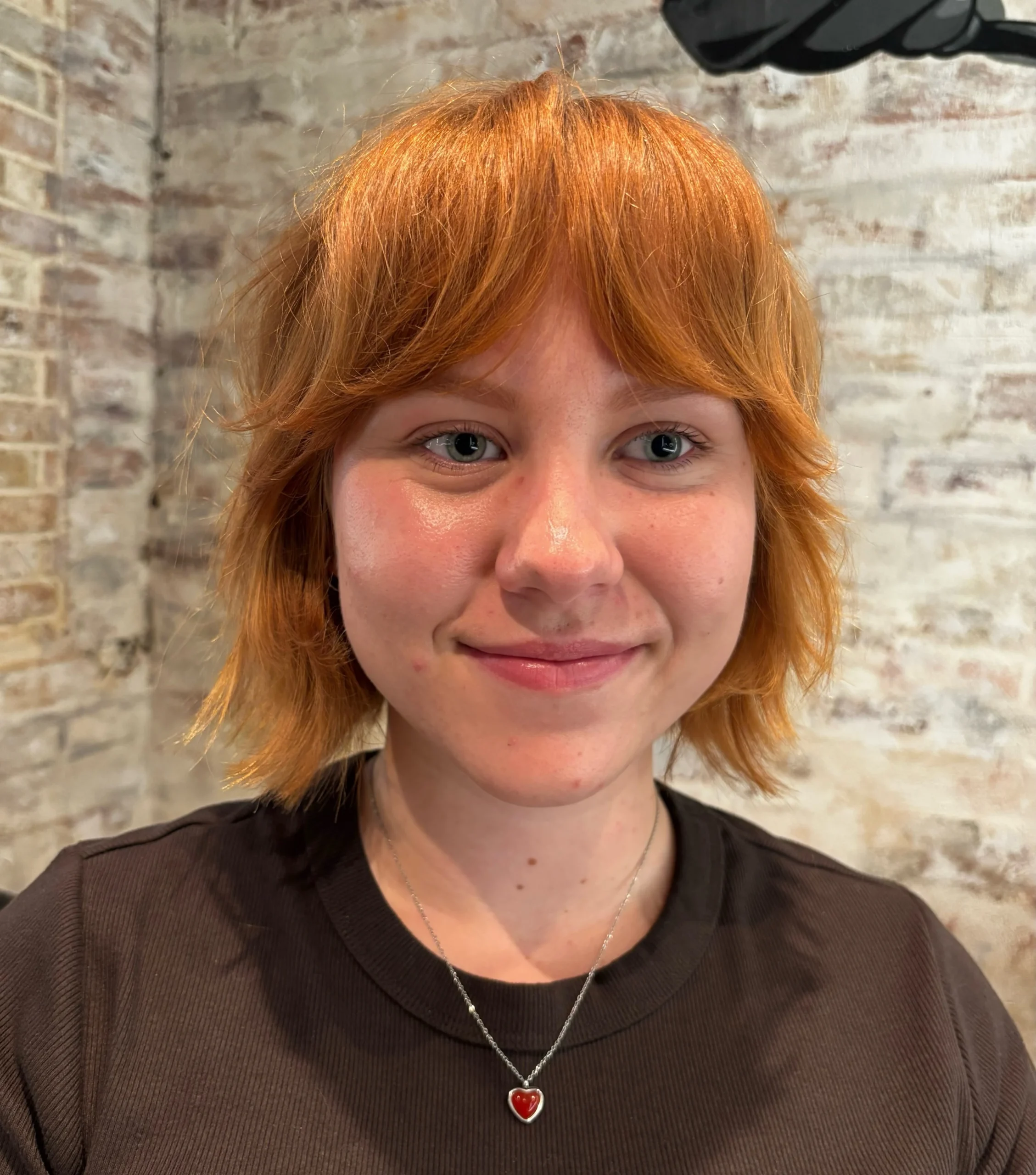 Woman with thin fine hair wearing a shaggy bob styled with a clean center part
