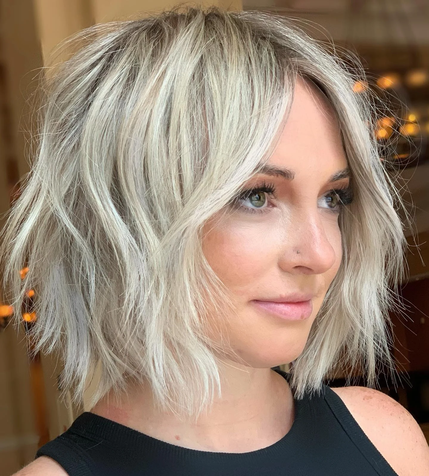 Woman with thin fine hair wearing a shaggy bob styled with extra lift and fullness at the crown