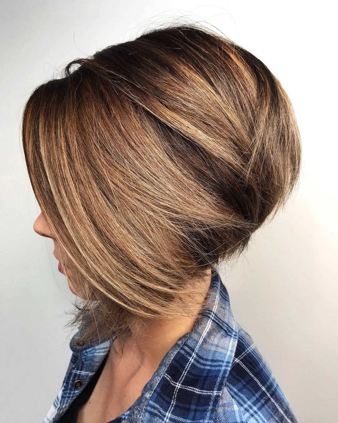 Woman with thin fine hair wearing a shaggy bob with extra layering built into the nape