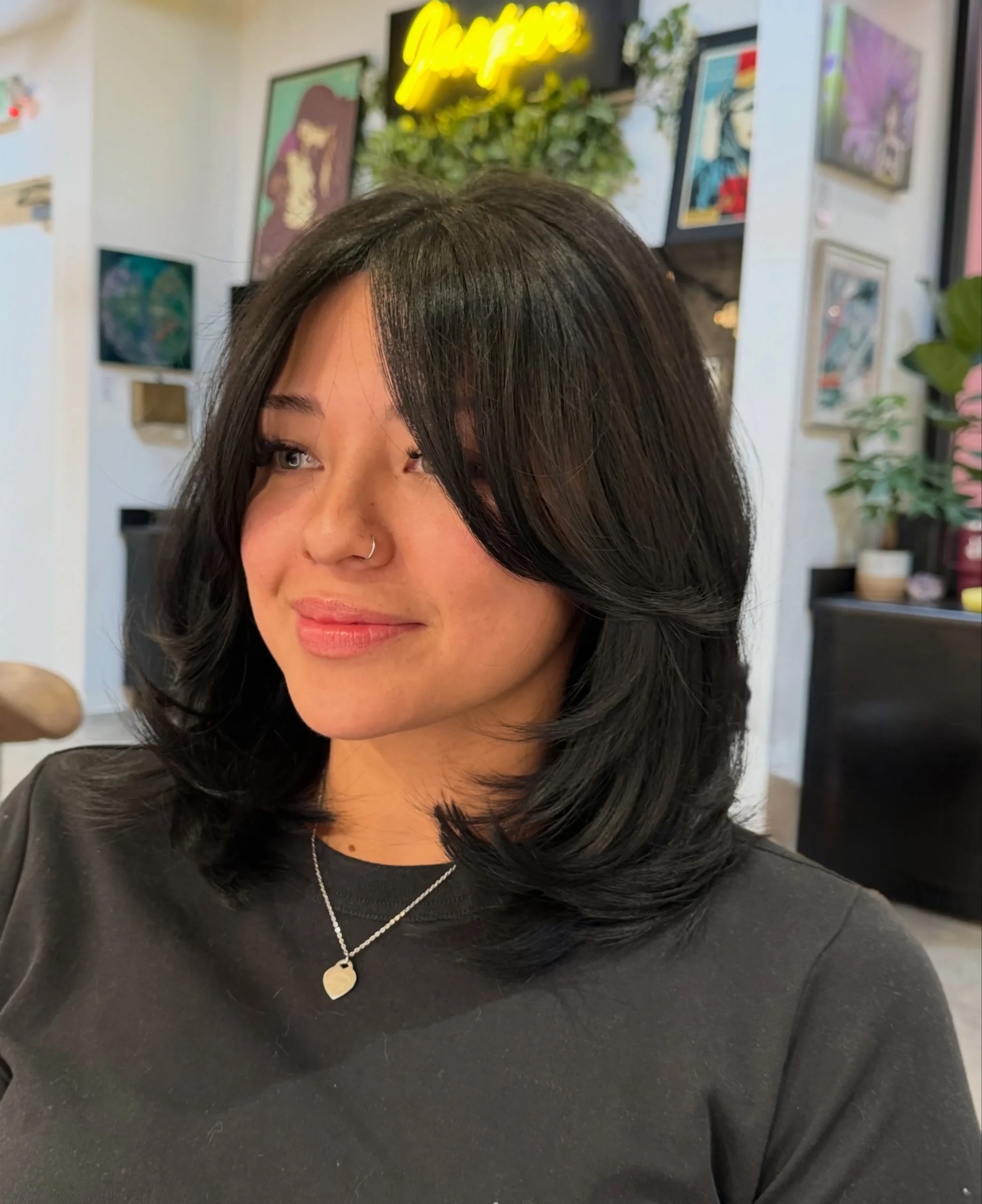 Woman with thin fine hair wearing a shaggy bob with longer pieces left at the front