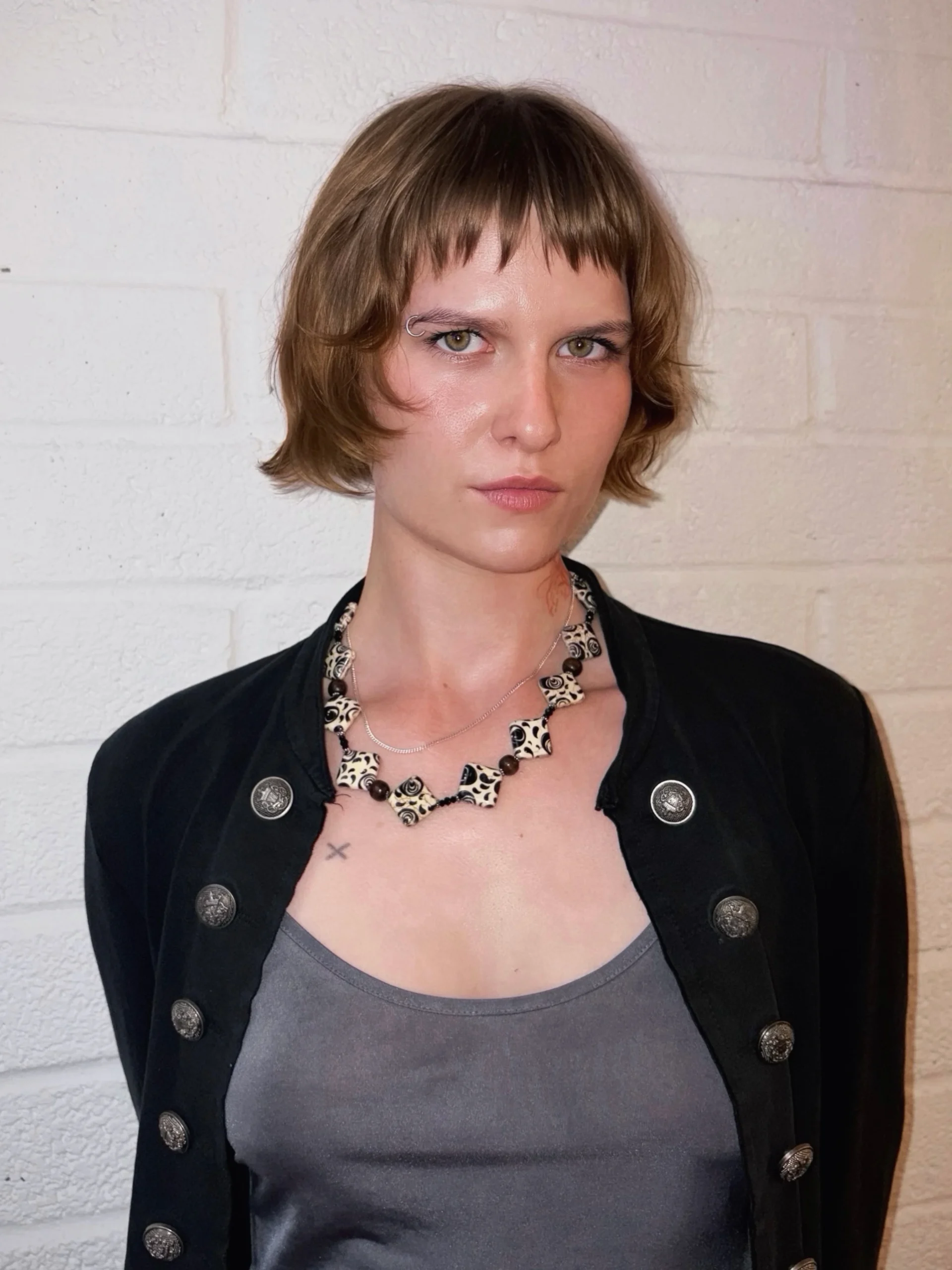 Woman with thin fine hair wearing a shaggy bob paired with a short micro fringe
