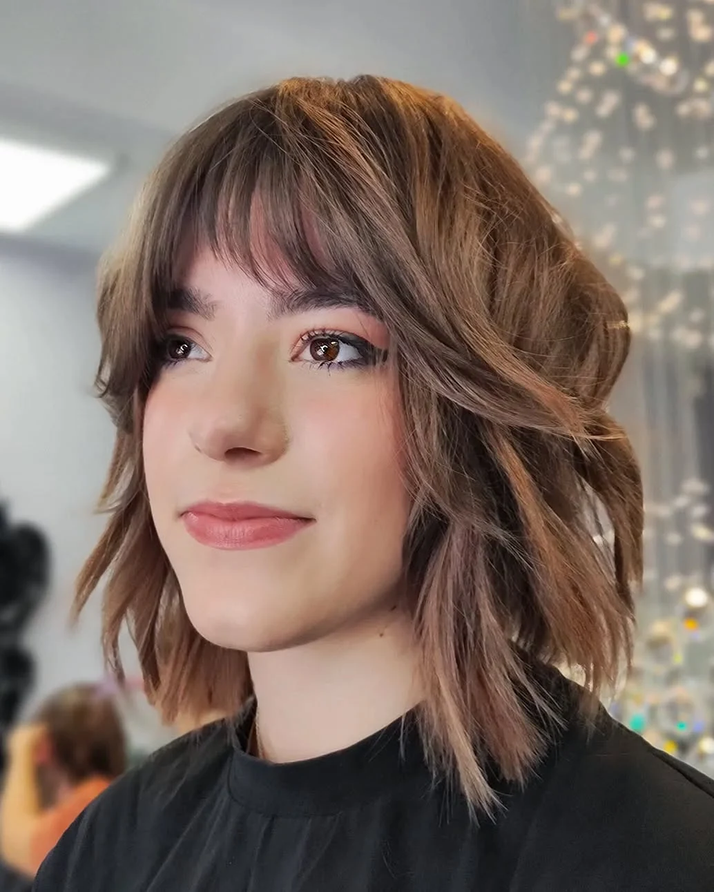 Woman with thin fine hair wearing a shaggy bob paired with piece-y, textured bangs