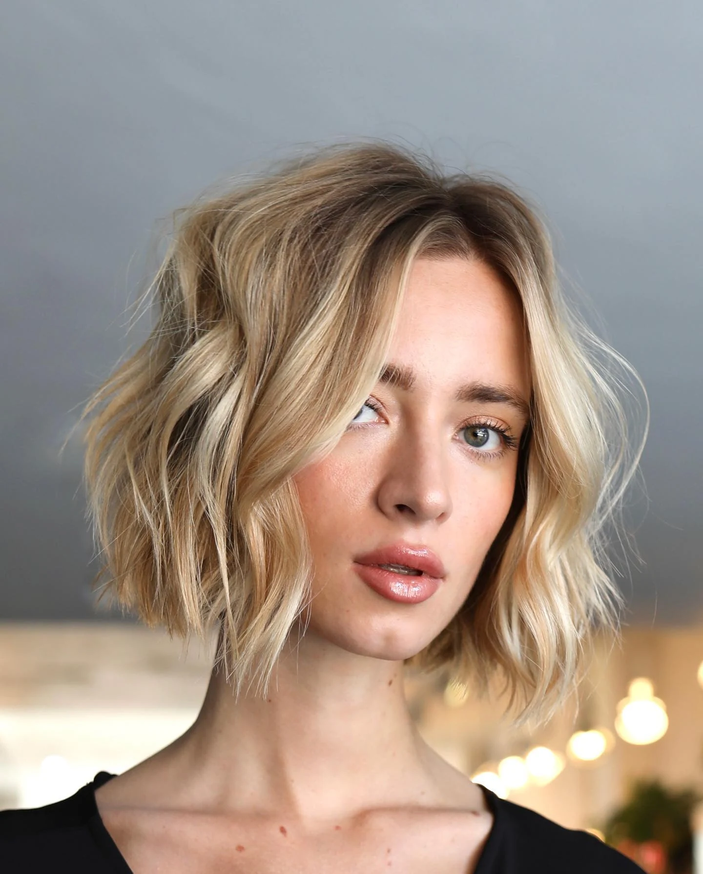 Woman with thin fine hair wearing a shaggy bob with softly blunt, rounded ends