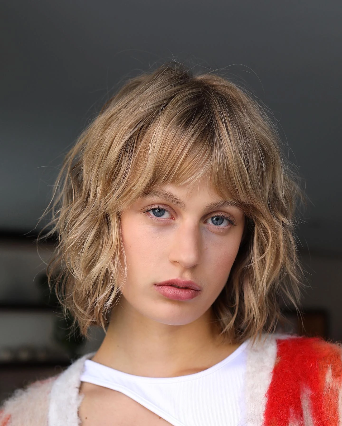 Woman with thin fine hair wearing a shaggy bob styled with textured layers and lifted roots