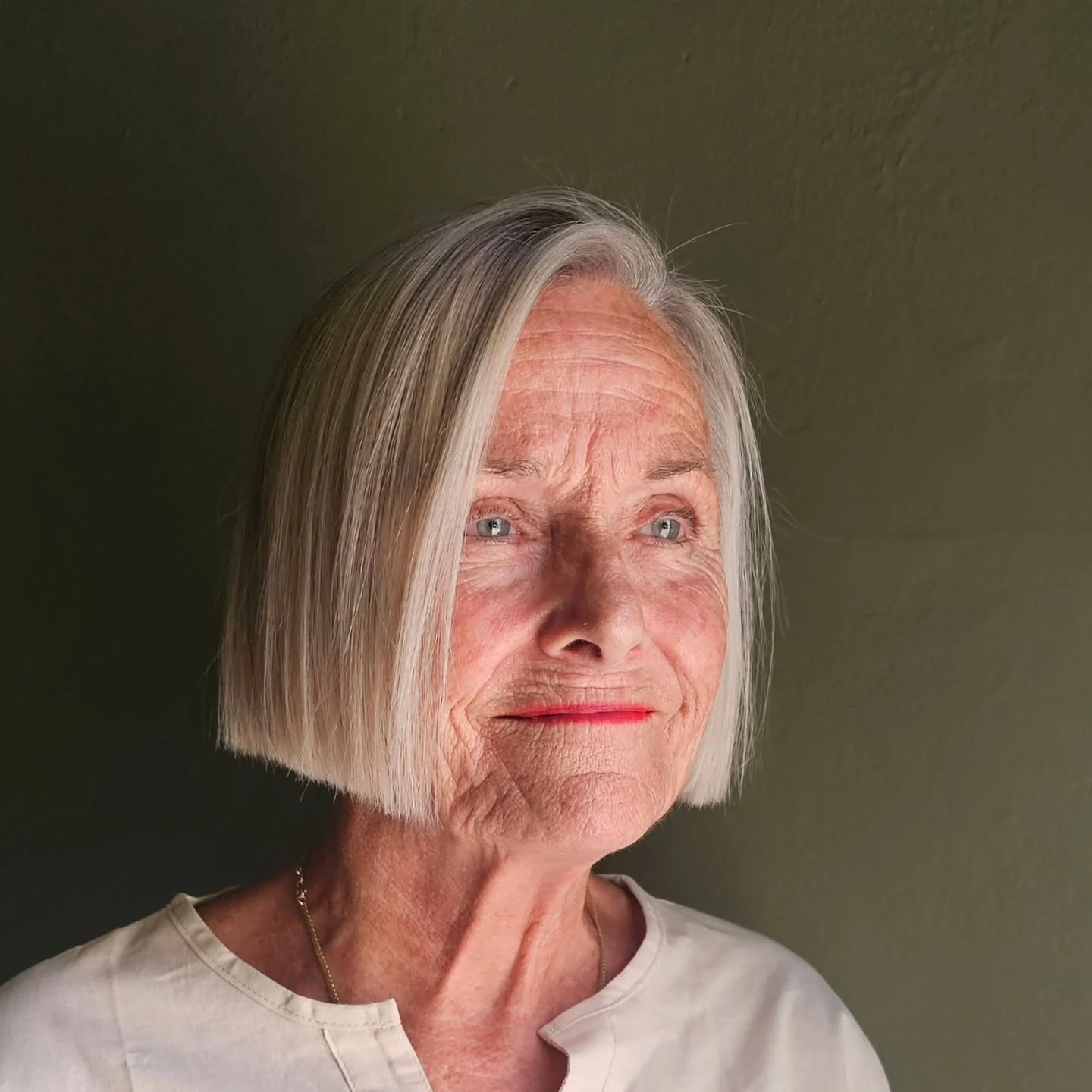 Woman over 60 with bob hairstyle styled smooth and polished for a special occasion
