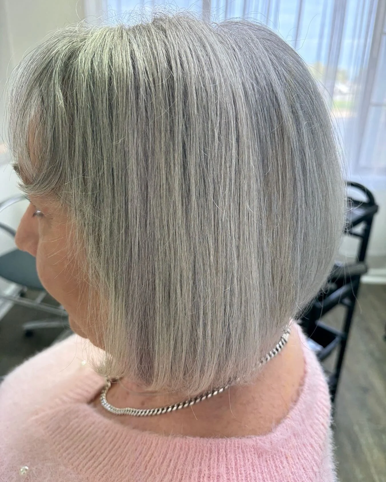 Woman over 60 with stacked bob haircut featuring volume in the back
