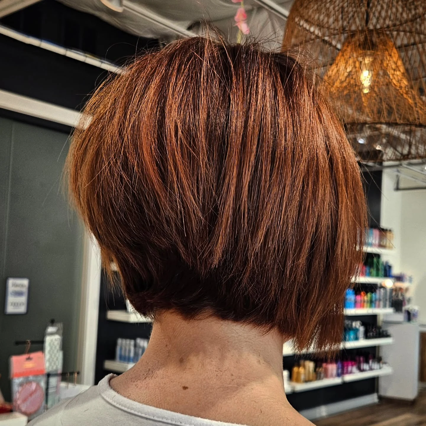 Woman with thin fine hair wearing a stacked shaggy bob with fullness at the back
