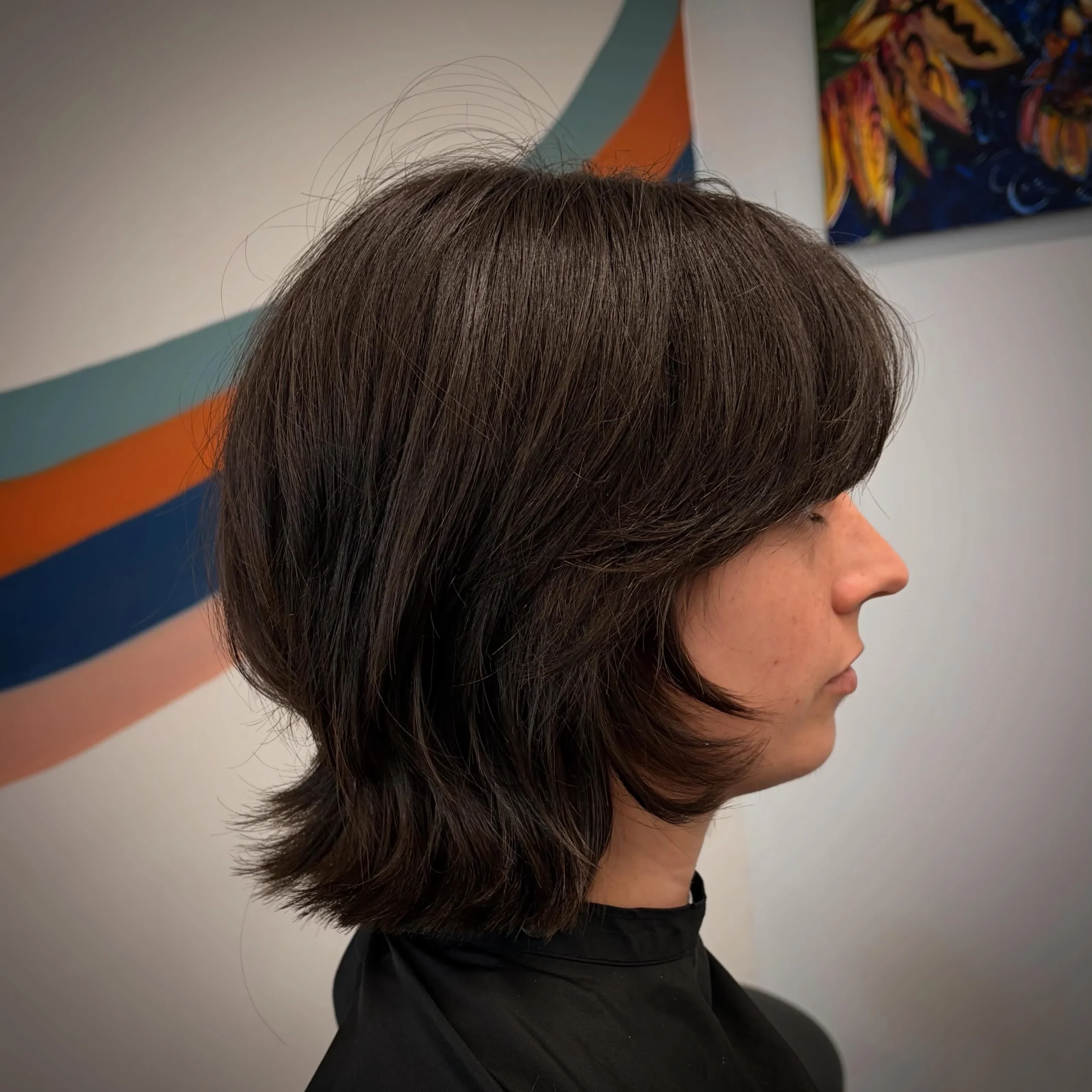 Woman with thin fine hair wearing a textured shag bob paired with soft curtain bangs