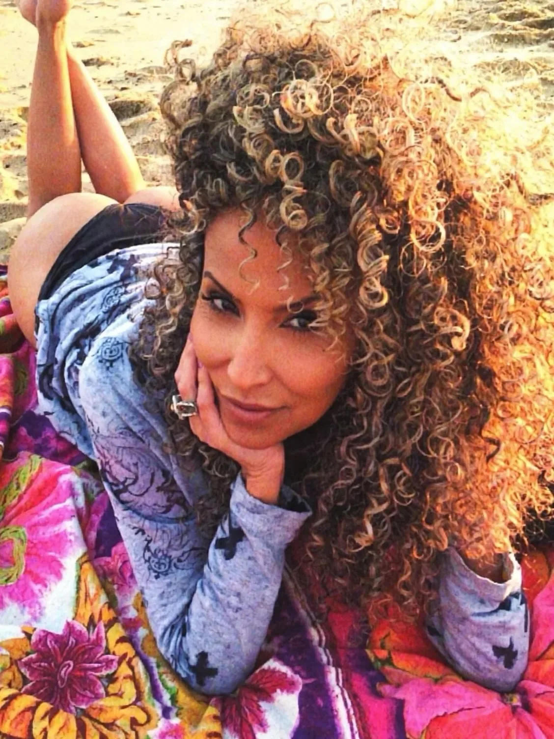 Woman over 50 with fine hair wearing voluminous curls with lifted roots