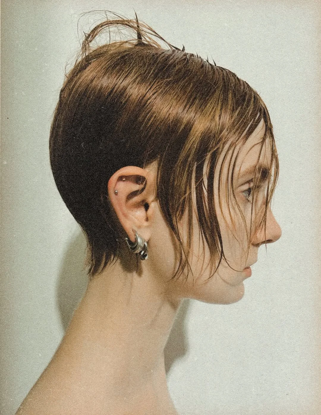 Woman with an edgy pixie styled with a glossy, wet-look slicked finish