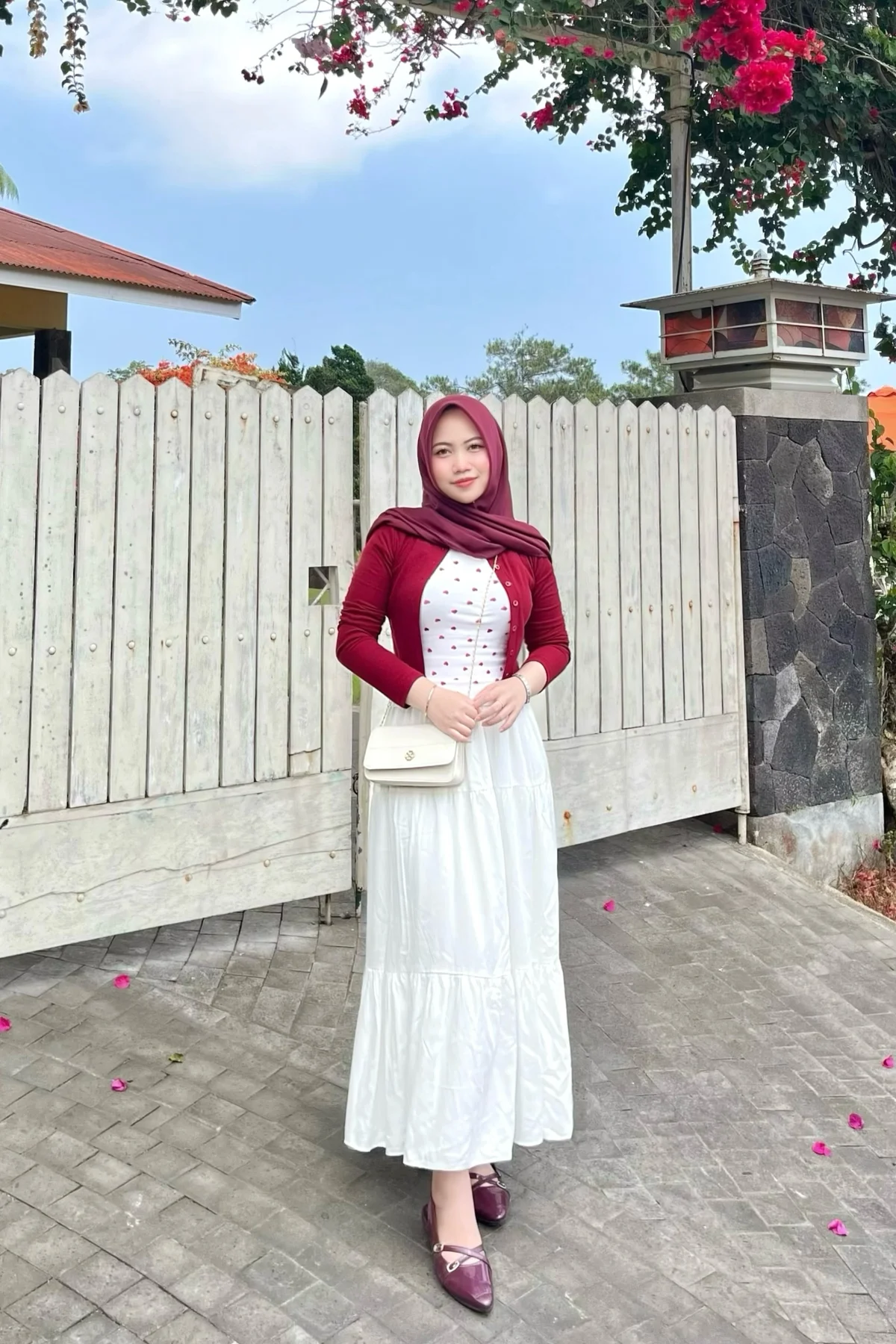 Woman in burgundy sweater and cream pleated maxi skirt with hijab, an elegant casual outfit