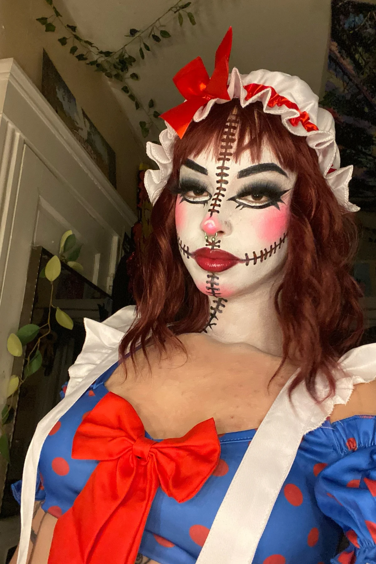 Woman over 50 in patchwork clothes with yarn hair, a DIY rag doll Halloween costume