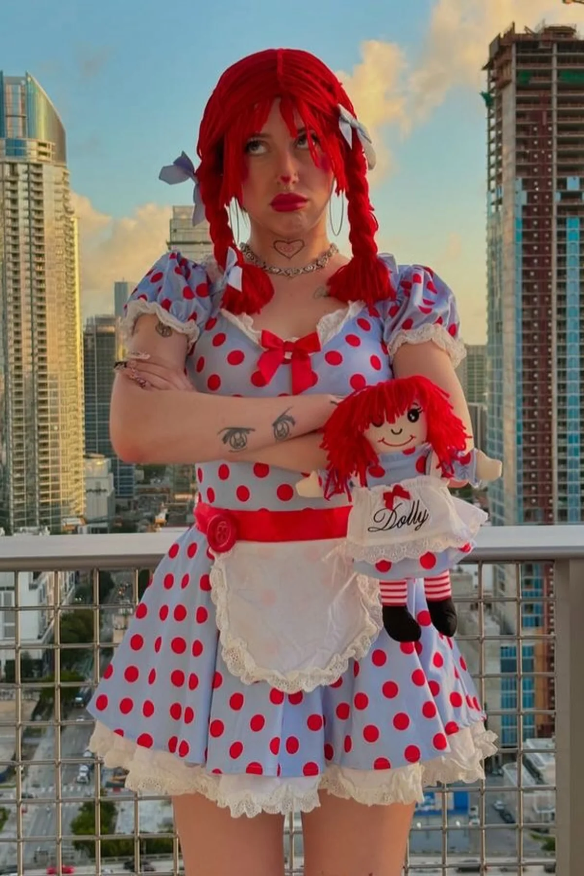 Woman in her 50s in a patchwork dress with yarn pigtails and stitched face paint, a creepy rag doll solo horror Halloween costume
