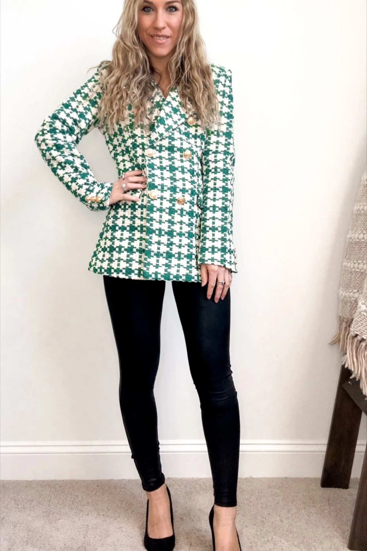 Woman in green houndstooth tweed blazer and black pants at Christmas
