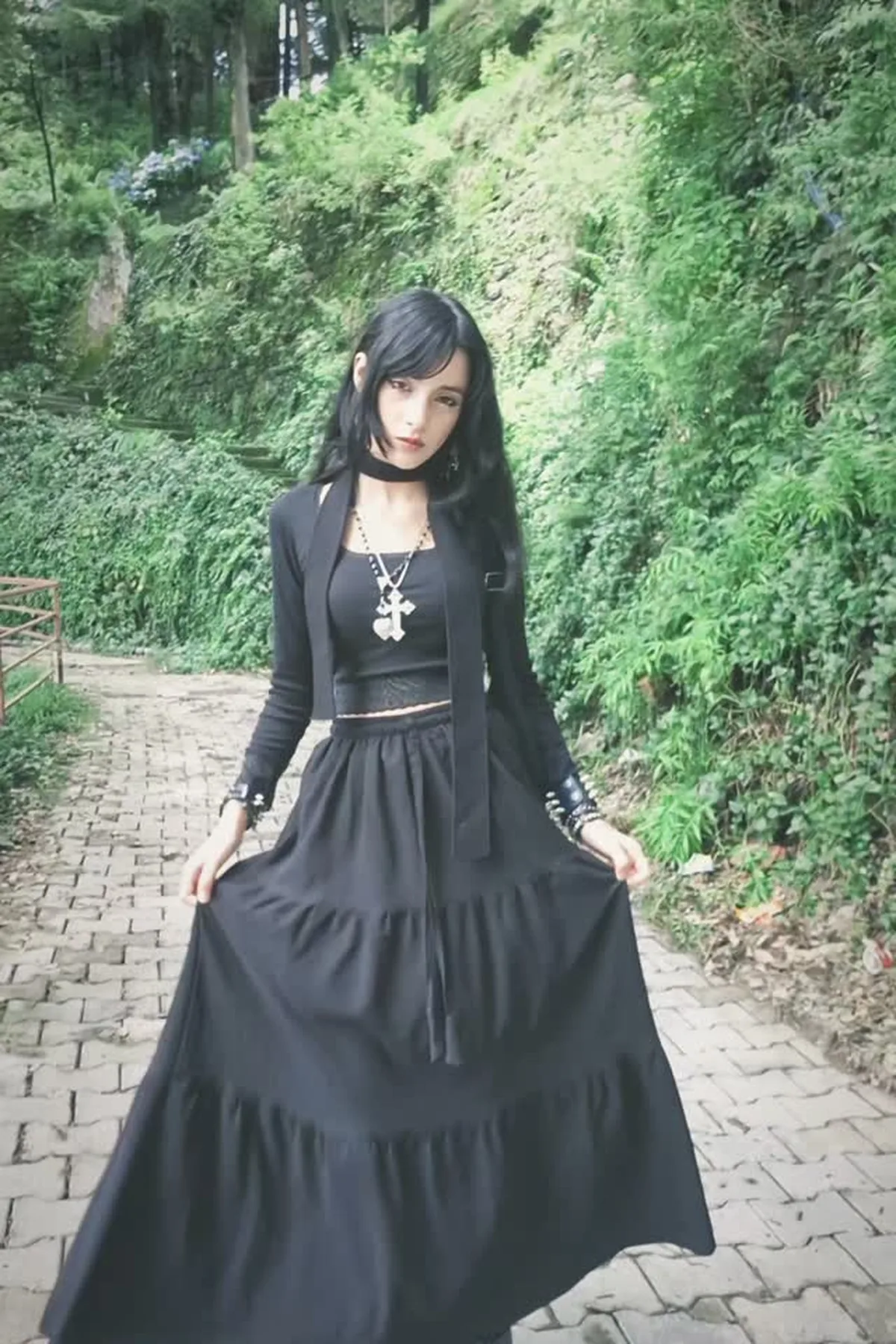 Woman in a black cardigan and jeans, a casual gothic Halloween costume for women over 50
