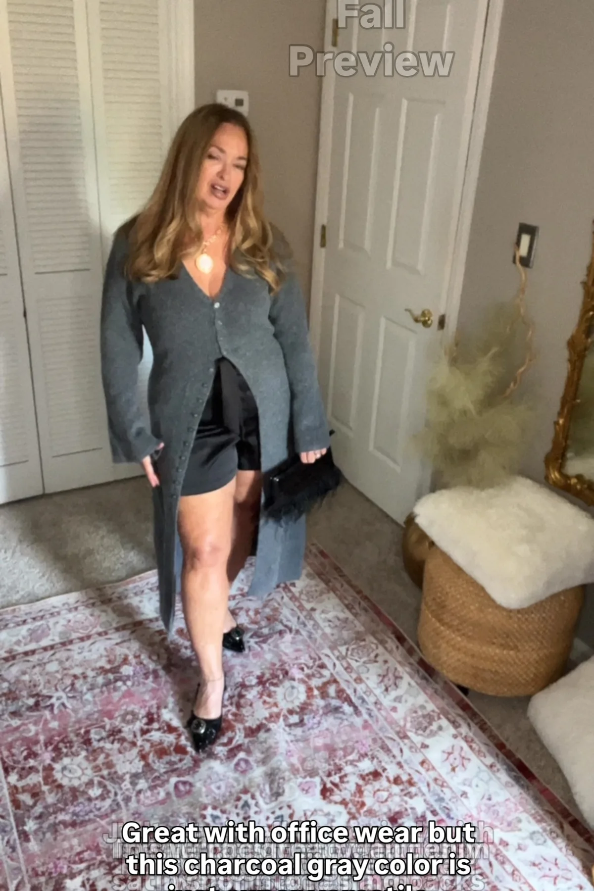 Woman in a charcoal cardigan and black jeans, a moody gothic Halloween outfit