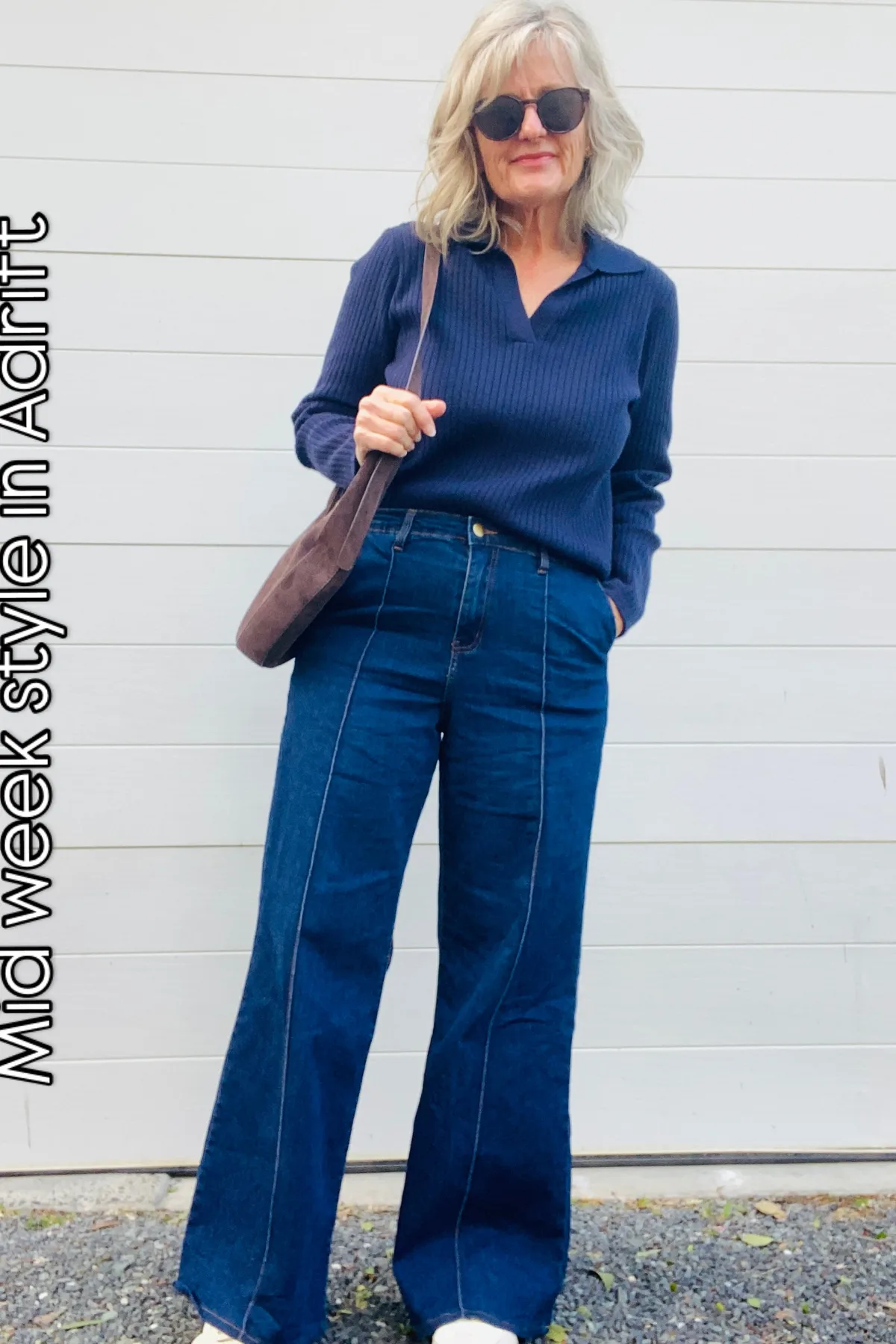 Woman in a navy chunky knit and jeans, easy gothic Halloween costumes for casual days