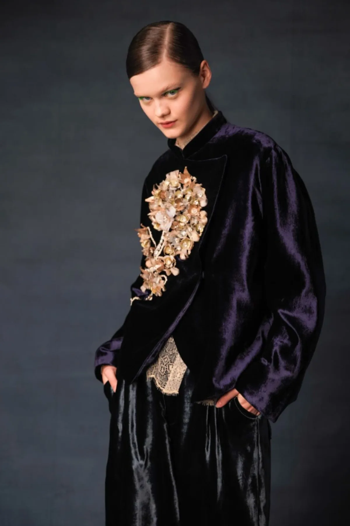 Woman in a plum velvet jacket and wide-leg trousers, a gothic Halloween outfit for women over 50