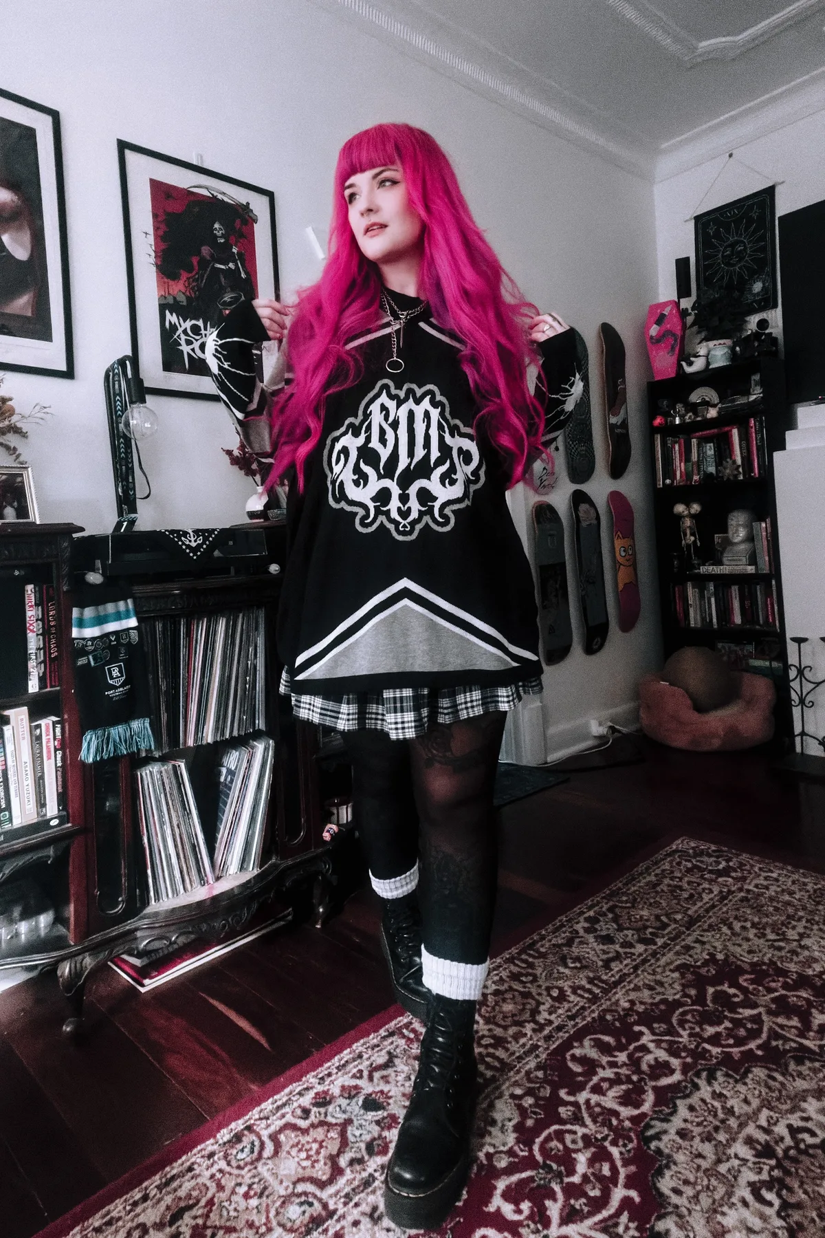 Woman in black track pants and an oversized knit, a comfy gothic Halloween costume