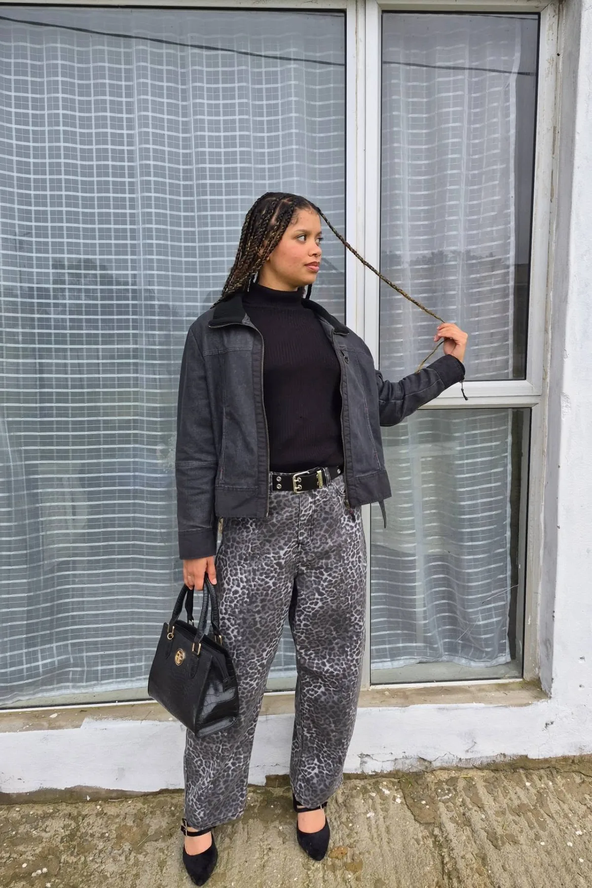Woman in leopard pants and a black turtleneck, a demon cat plus size Halloween costume