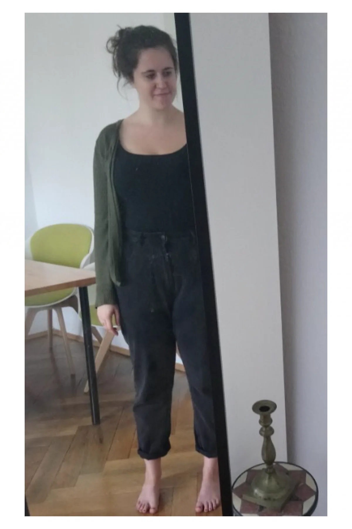 Woman in an olive maxi cardigan and black trousers, a plus size swamp witch Halloween costume
