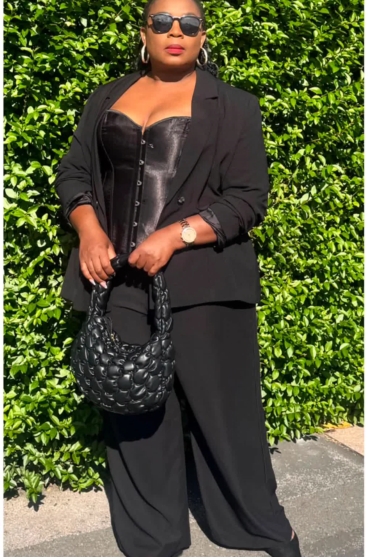 Woman in a black velvet blazer and wide-leg trousers, a chic plus size witch Halloween costume