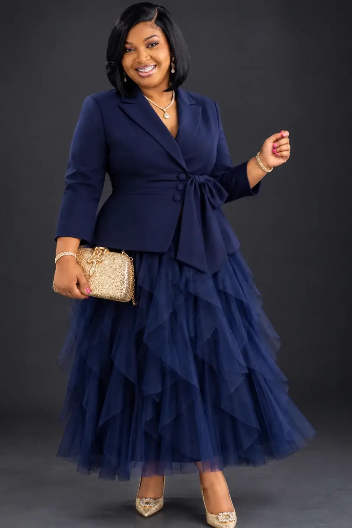 Woman in a navy velvet jacket and star tulle skirt, a celestial plus size witch Halloween costume