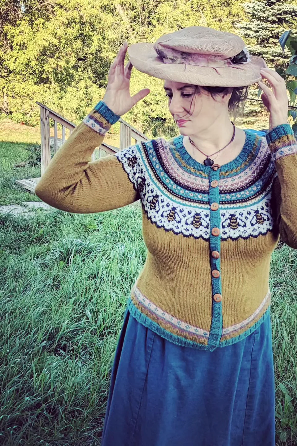 Woman in a mustard cardigan and floral skirt with a straw hat, a garden plus size witch costume